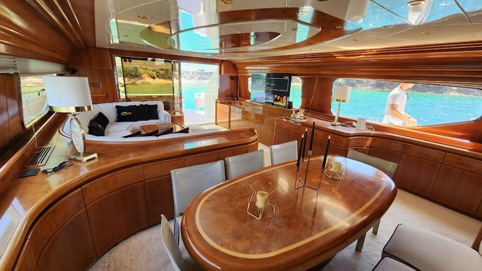a room with a table and chairs aboard THE ONE Yacht for Sale