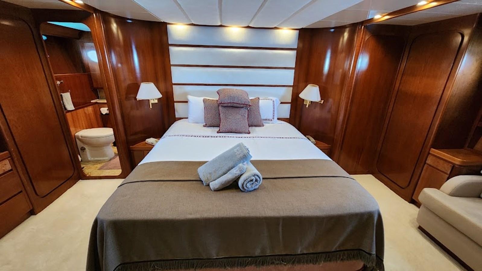 a bed in a room aboard THE ONE Yacht for Sale