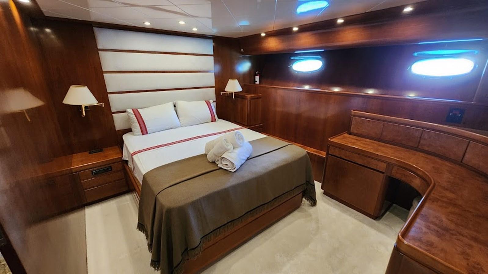 a room with a bed and a piano aboard THE ONE Yacht for Sale