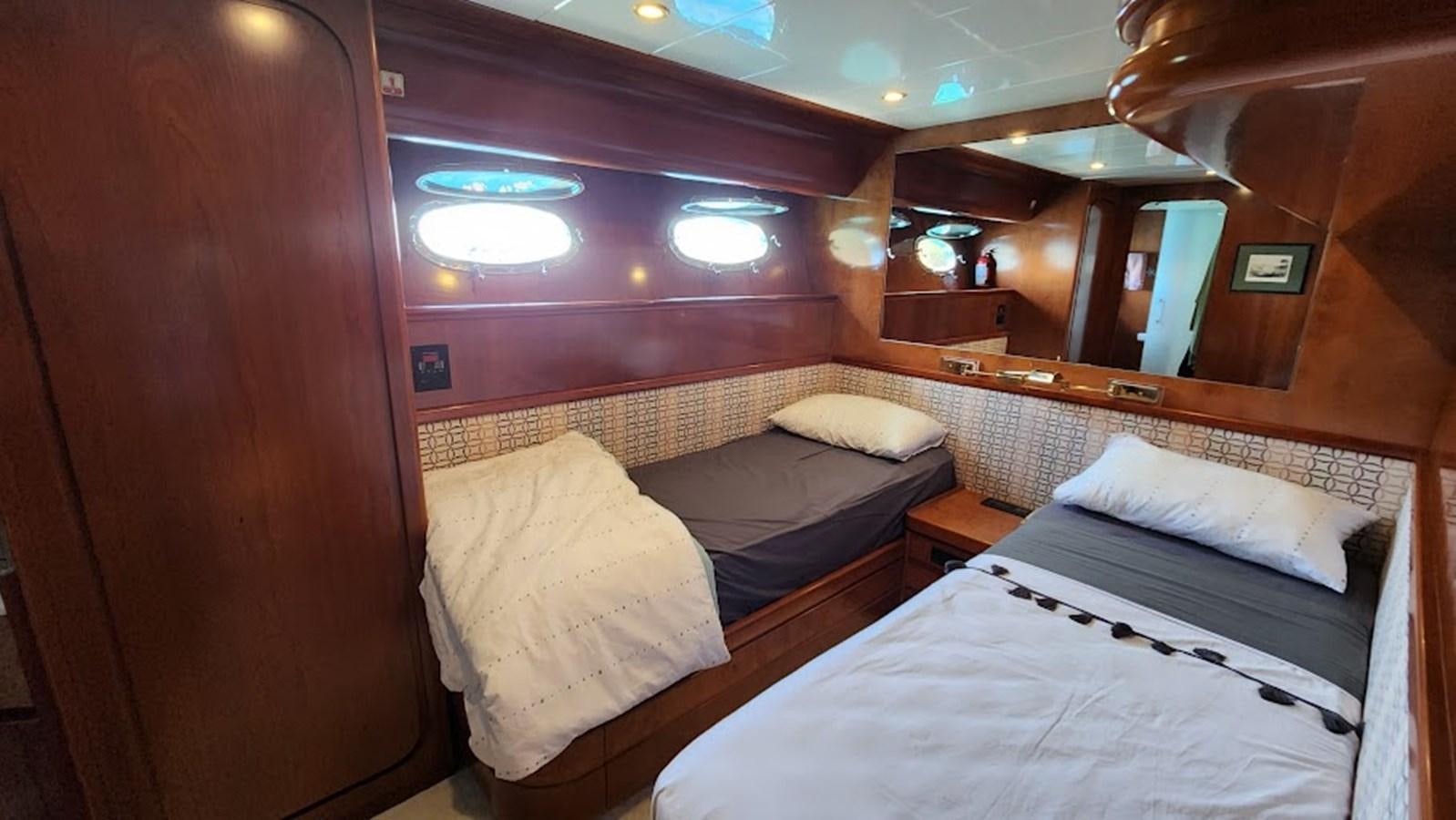 a room with three beds aboard THE ONE Yacht for Sale
