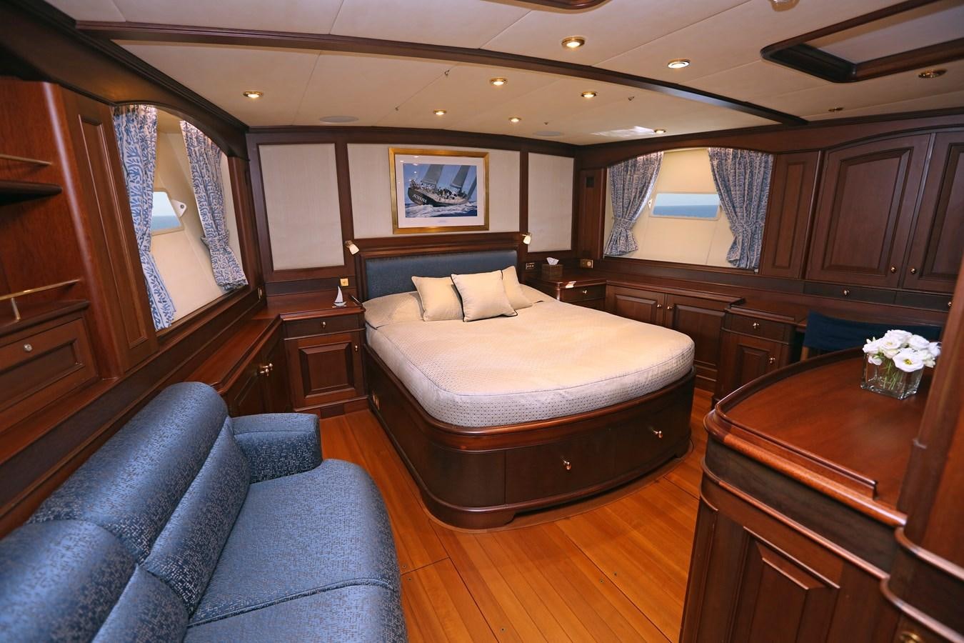 a bedroom with a bed and a desk aboard SOJANA Yacht for Sale