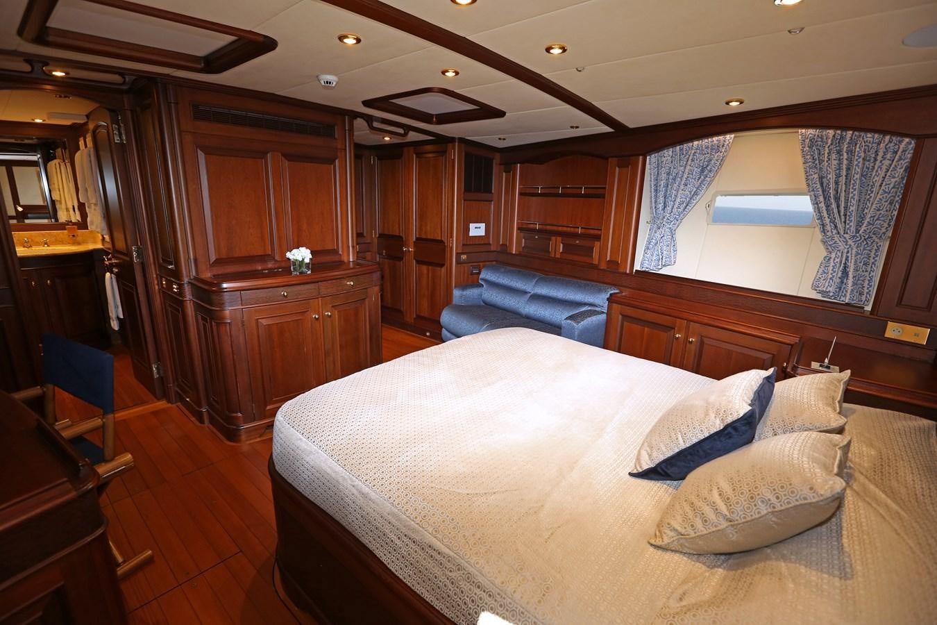 a bedroom with a bed and a desk aboard SOJANA Yacht for Sale
