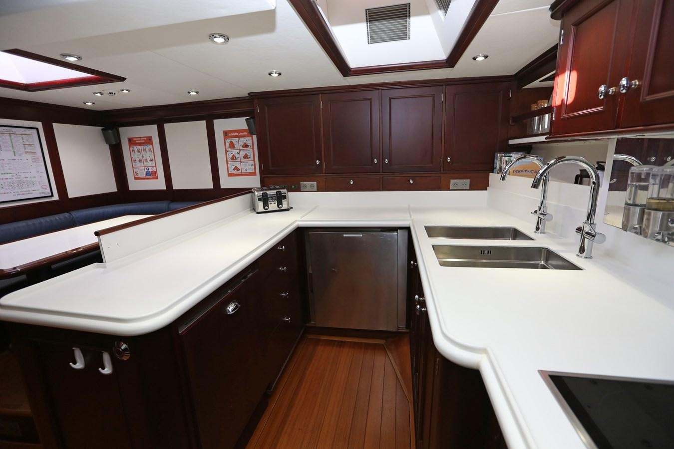 a kitchen with wooden cabinets aboard SOJANA Yacht for Sale