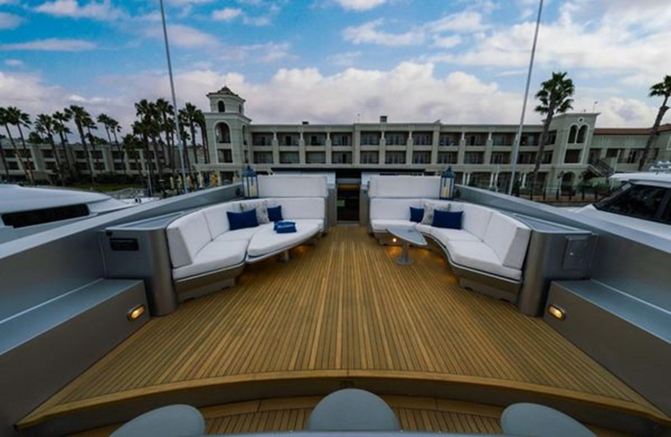 a deck with a pool and a building in the background aboard 2003 BAGLIETTO 38M FAST FLY Yacht for Sale