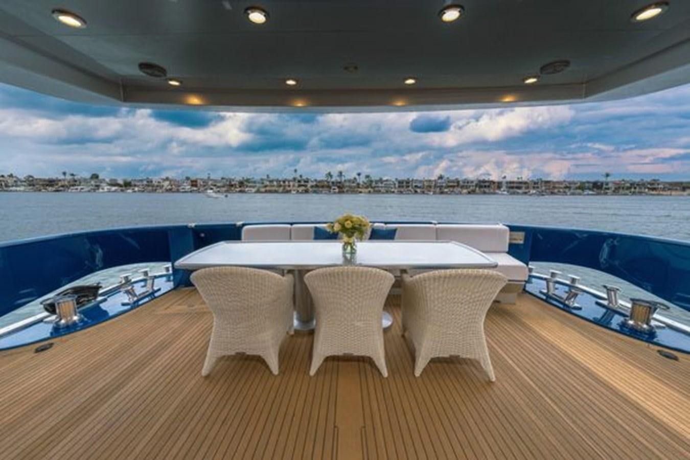 a table and chairs on a deck aboard 2003 BAGLIETTO 38M FAST FLY Yacht for Sale