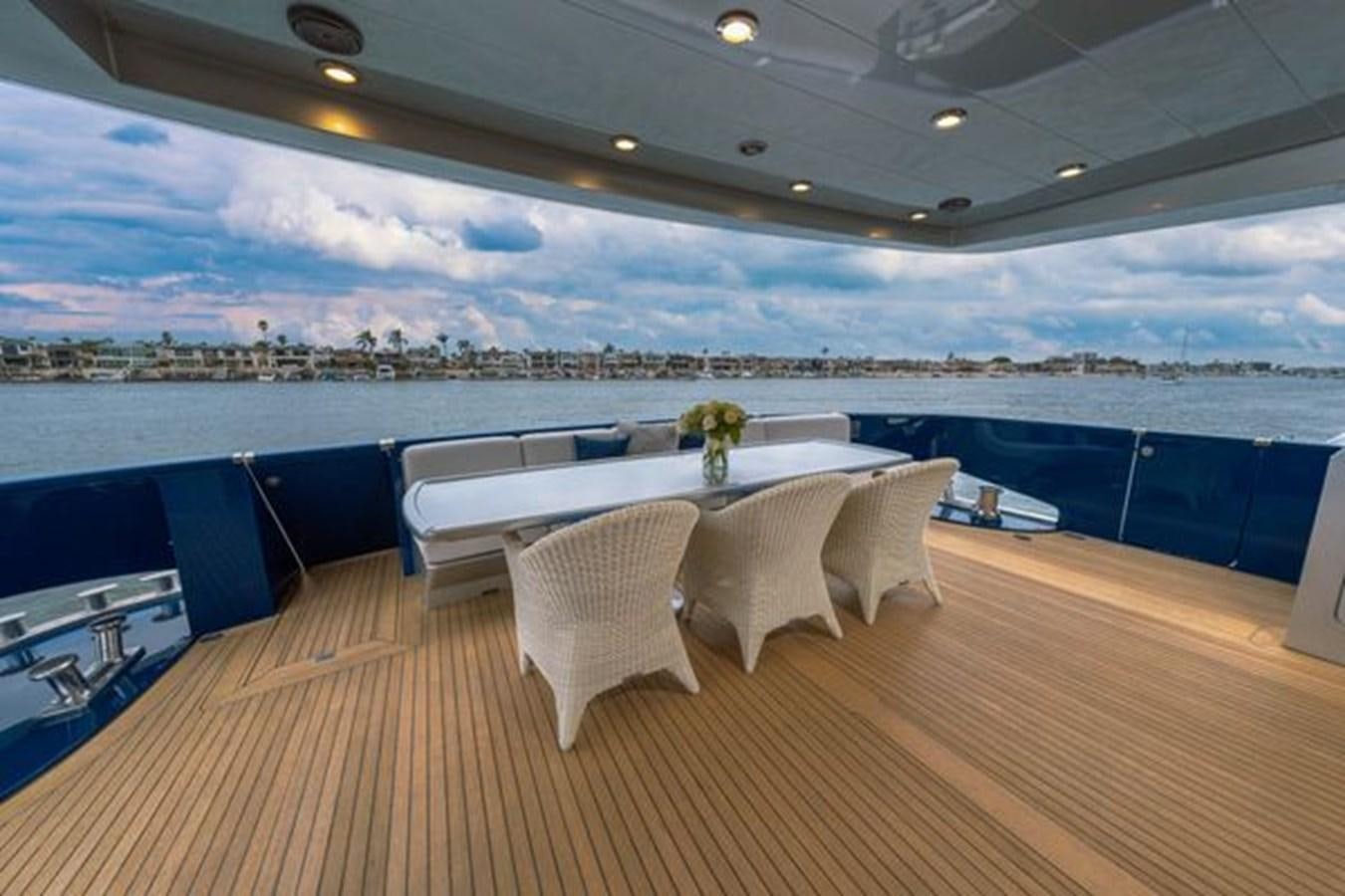 a table and chairs on a deck aboard 2003 BAGLIETTO 38M FAST FLY Yacht for Sale