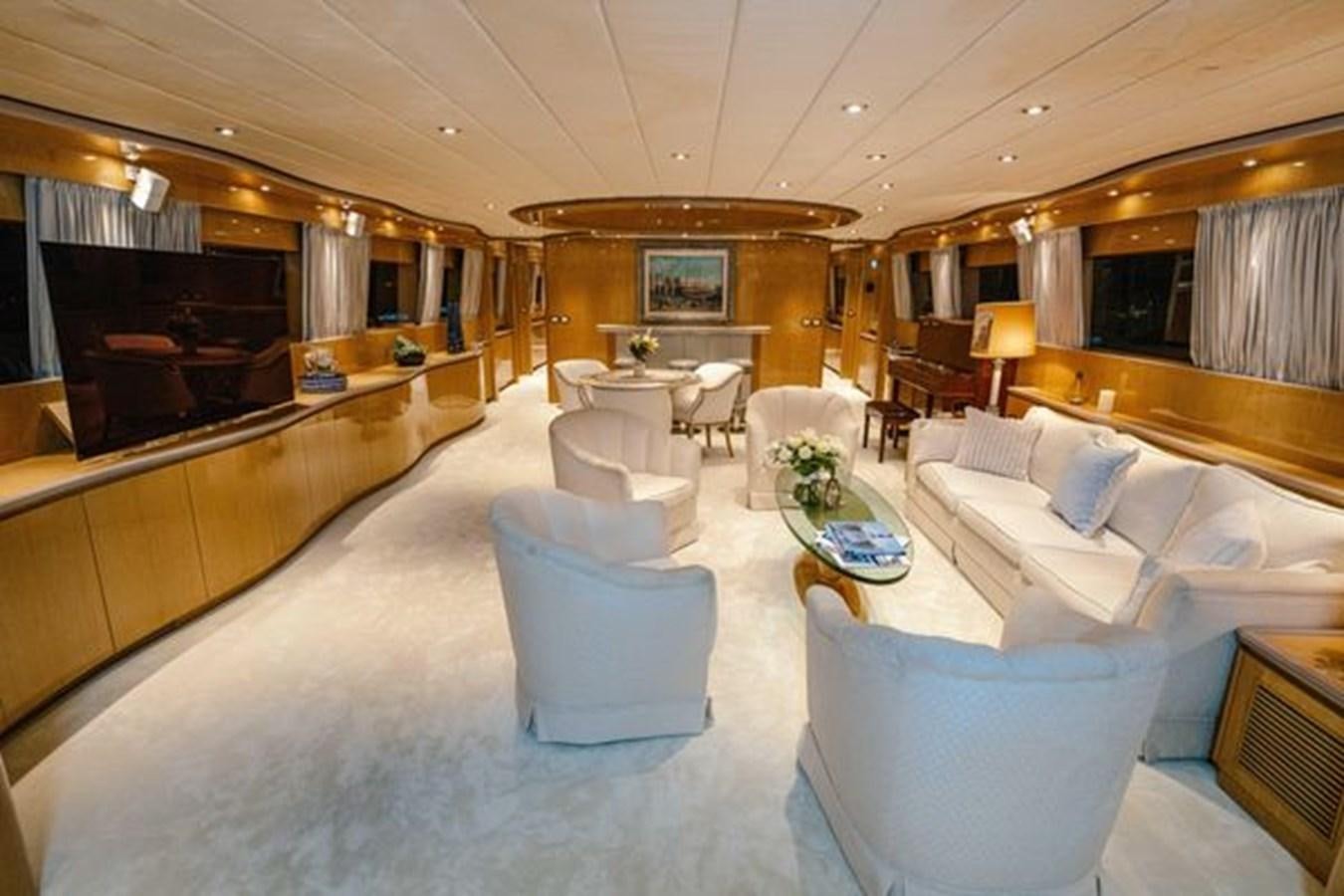 a large living room with a large couch and a piano aboard 2003 BAGLIETTO 38M FAST FLY Yacht for Sale