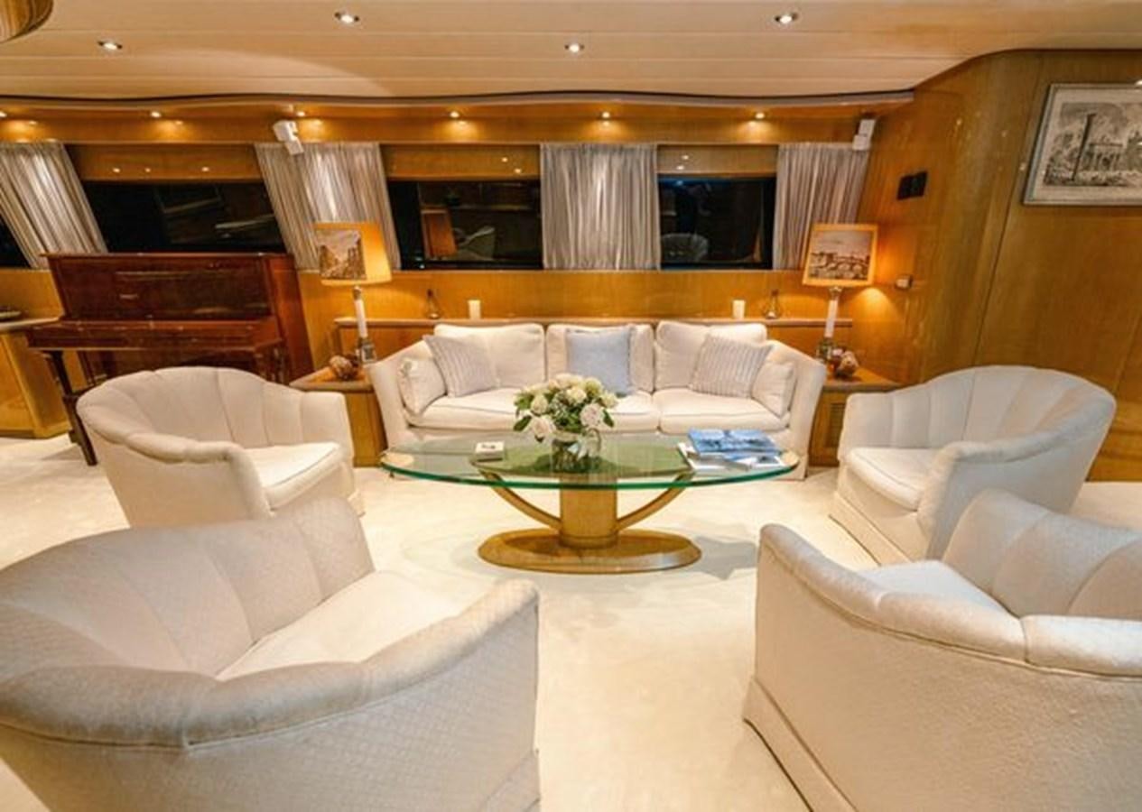 a living room with a table and couches aboard 2003 BAGLIETTO 38M FAST FLY Yacht for Sale