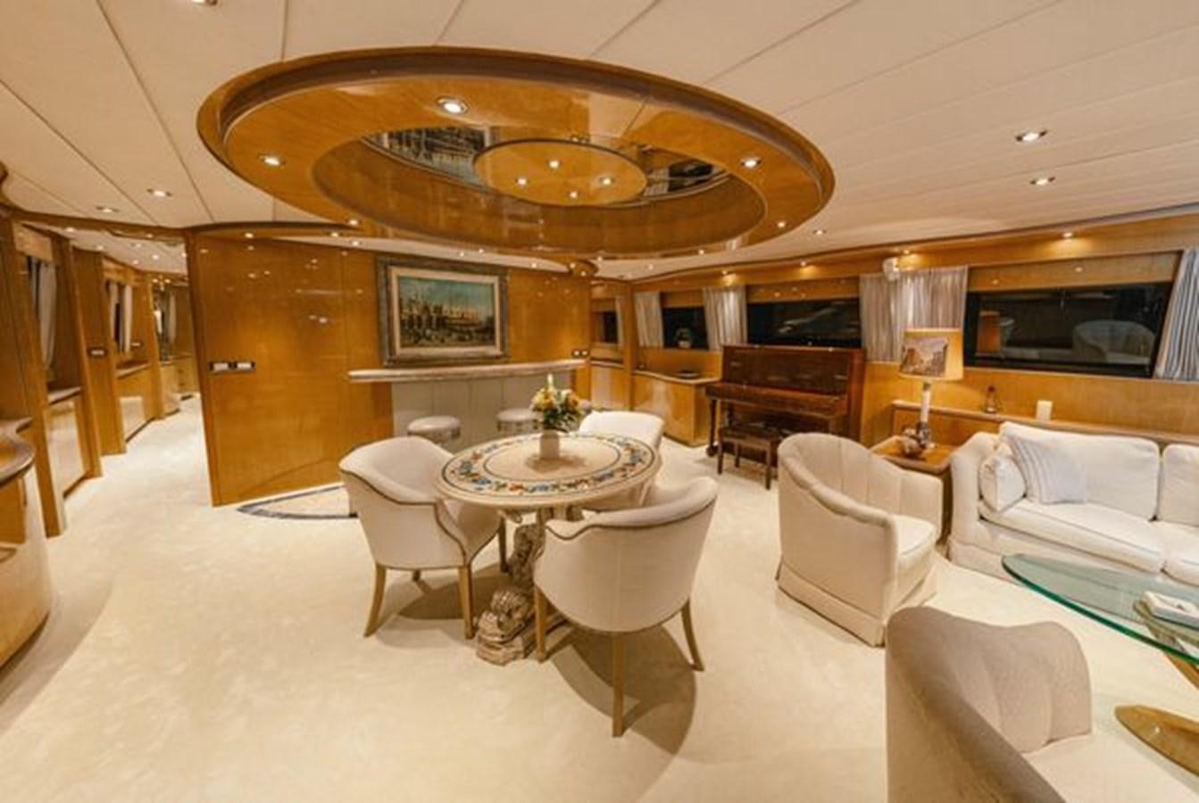 a large living room with a large chandelier aboard 2003 BAGLIETTO 38M FAST FLY Yacht for Sale
