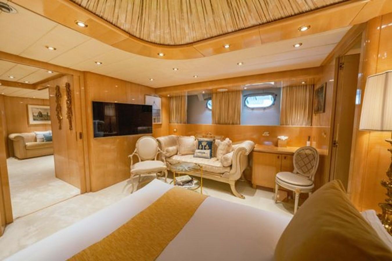 a room with a couch and a television aboard 2003 BAGLIETTO 38M FAST FLY Yacht for Sale