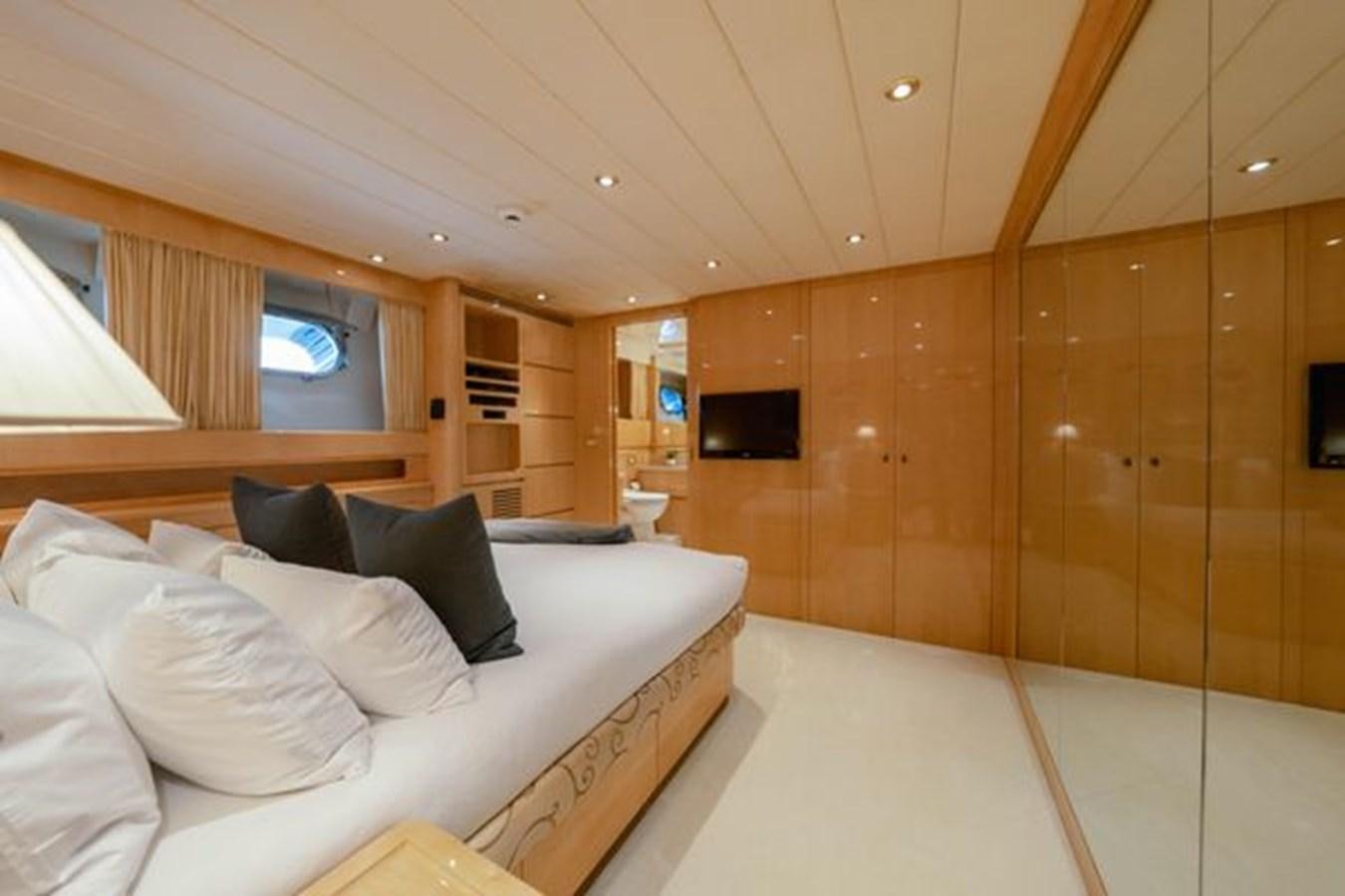 a room with a bed and a window aboard 2003 BAGLIETTO 38M FAST FLY Yacht for Sale