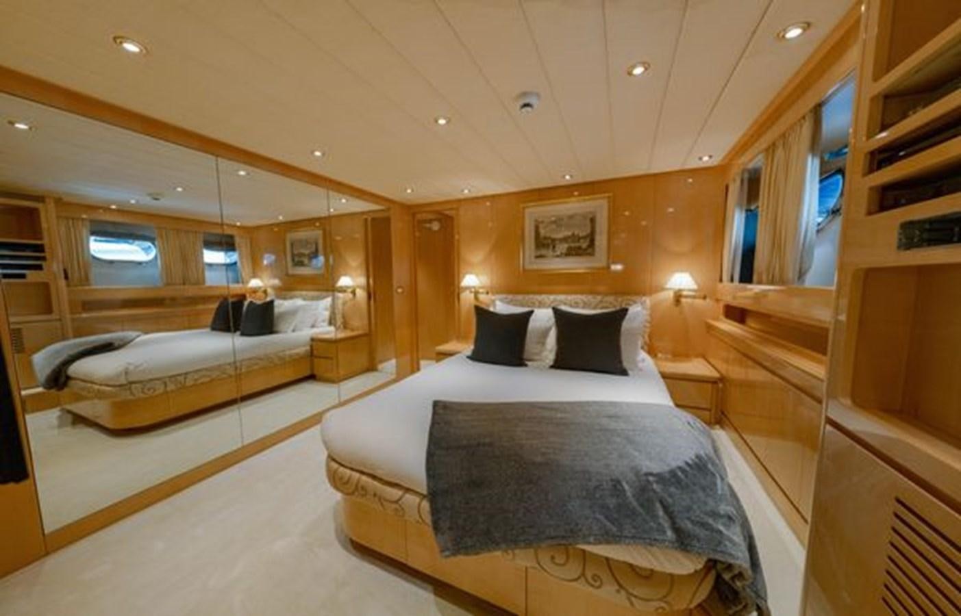 a room with a bed and a mirror aboard 2003 BAGLIETTO 38M FAST FLY Yacht for Sale