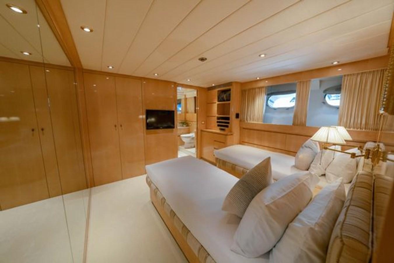 a room with a bed and a couch aboard 2003 BAGLIETTO 38M FAST FLY Yacht for Sale