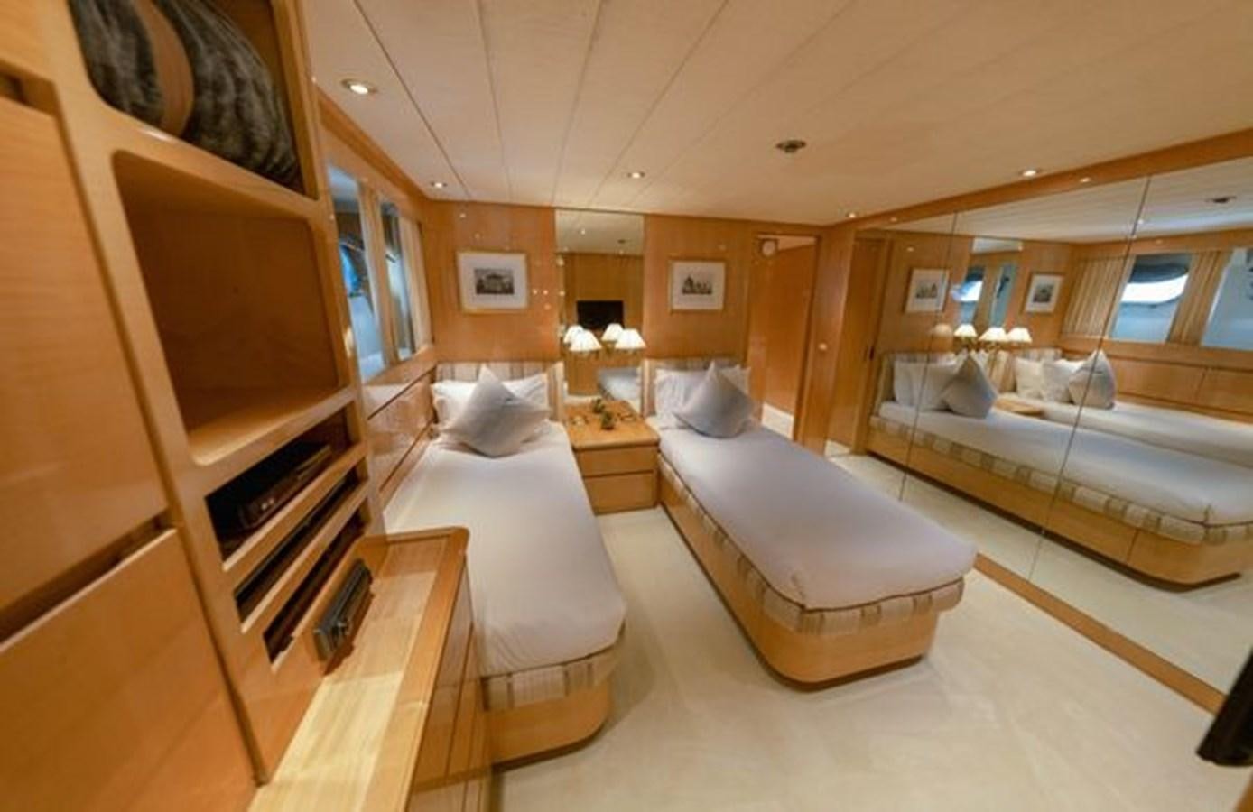 a room with a bed and a television aboard 2003 BAGLIETTO 38M FAST FLY Yacht for Sale