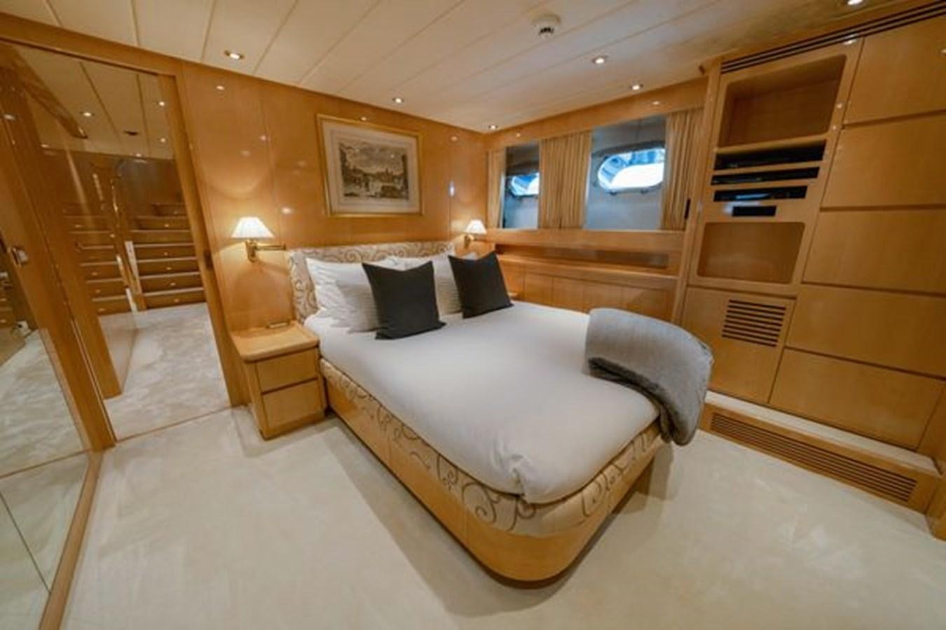 a room with a bed and a wood door aboard 2003 BAGLIETTO 38M FAST FLY Yacht for Sale