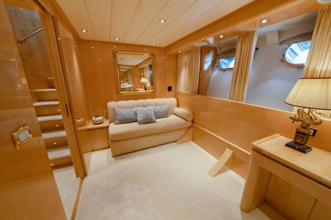 a living room with a bed and a table aboard 2003 BAGLIETTO 38M FAST FLY Yacht for Sale
