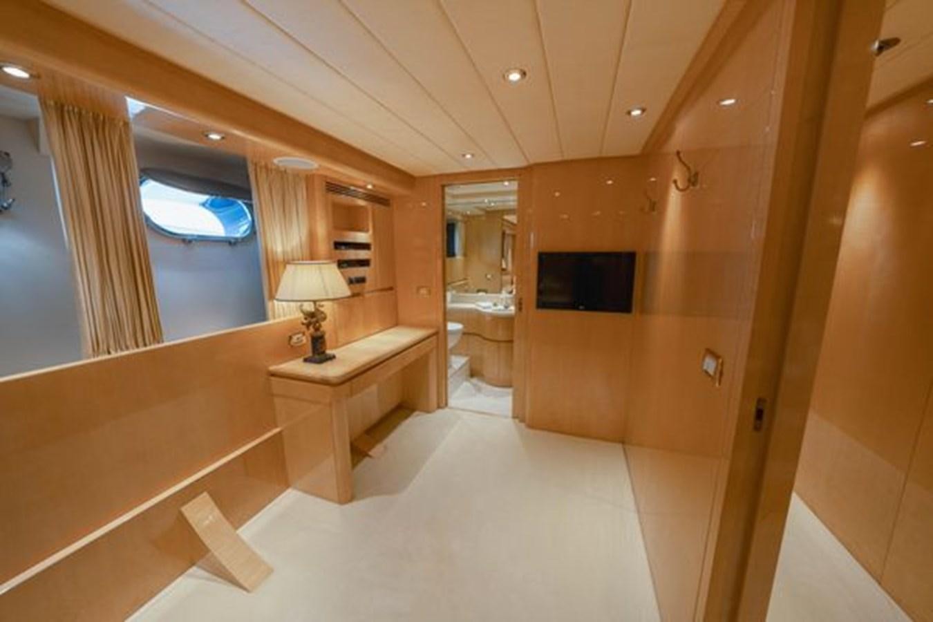 a room with a table and a mirror aboard 2003 BAGLIETTO 38M FAST FLY Yacht for Sale