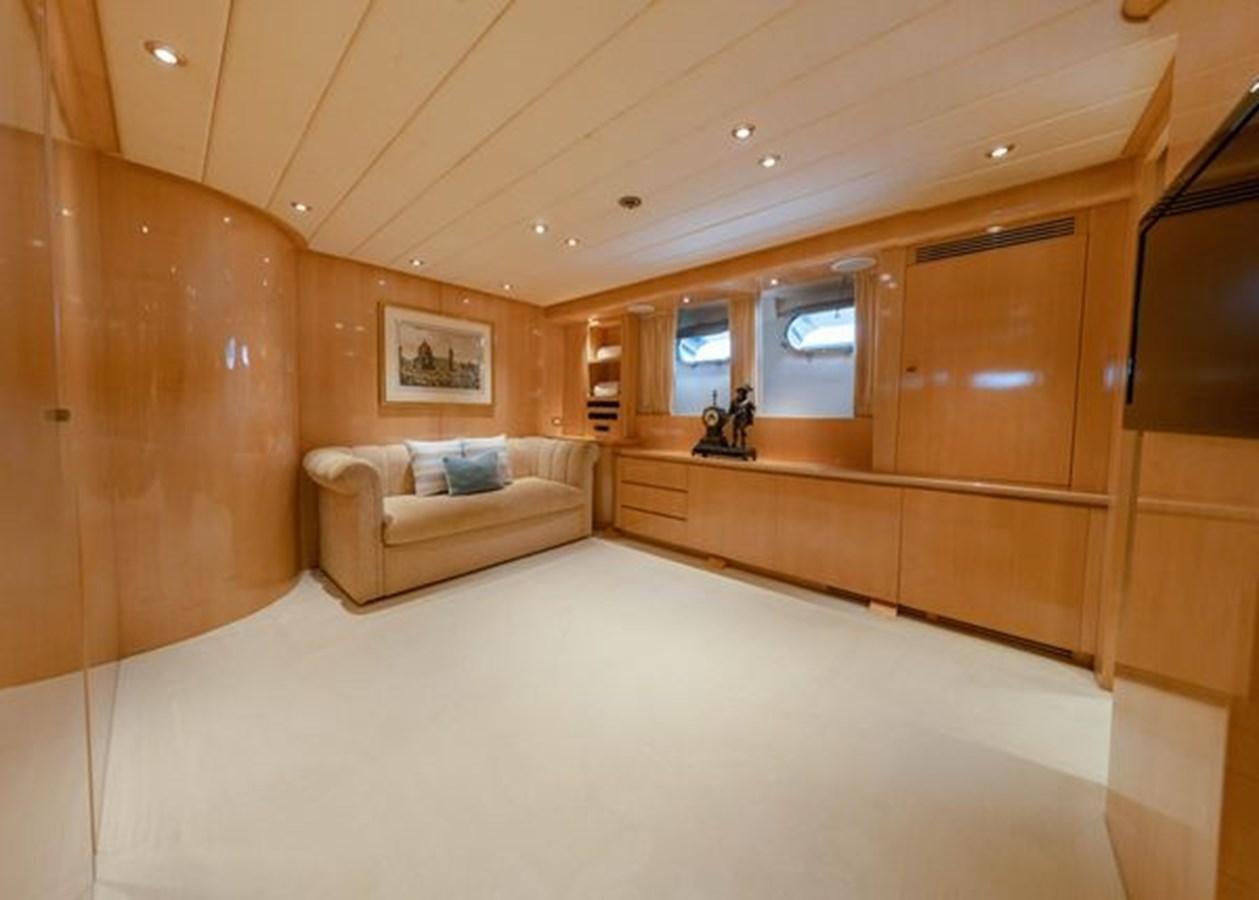 a room with a couch and a wood wall aboard 2003 BAGLIETTO 38M FAST FLY Yacht for Sale