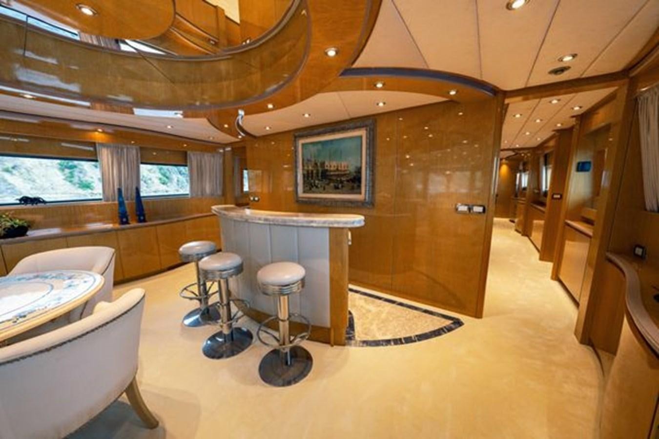 a room with tables and chairs aboard 2003 BAGLIETTO 38M FAST FLY Yacht for Sale