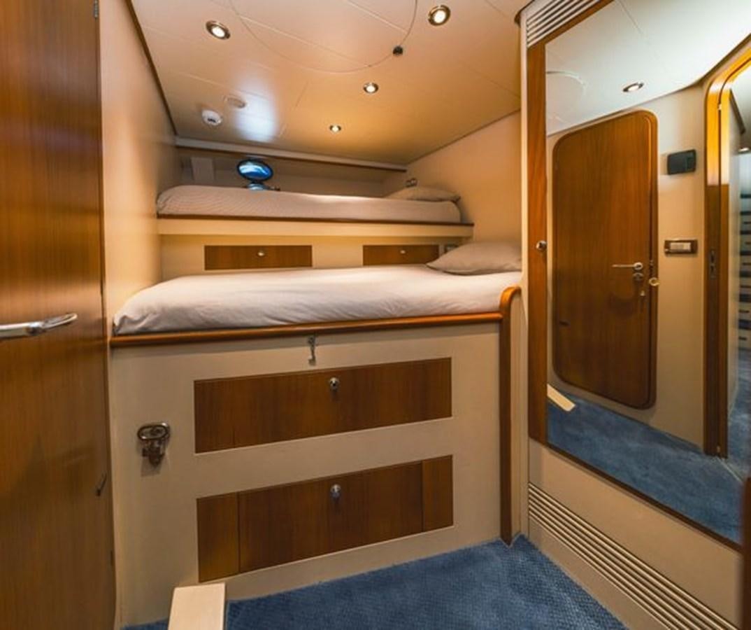 a room with a bed and a door aboard 2003 BAGLIETTO 38M FAST FLY Yacht for Sale