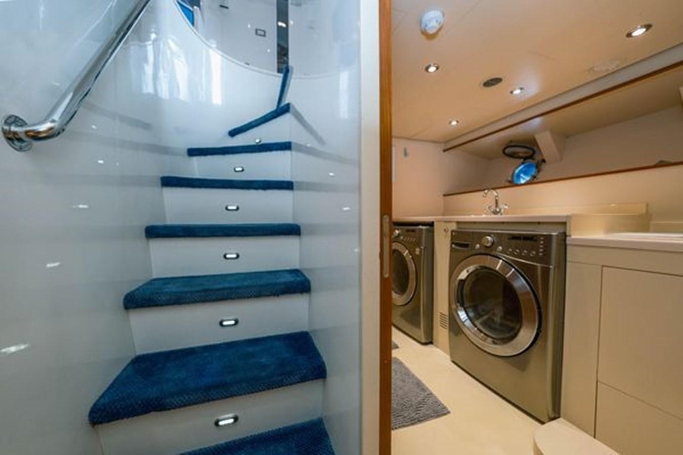 a washer and dryer in a room aboard 2003 BAGLIETTO 38M FAST FLY Yacht for Sale