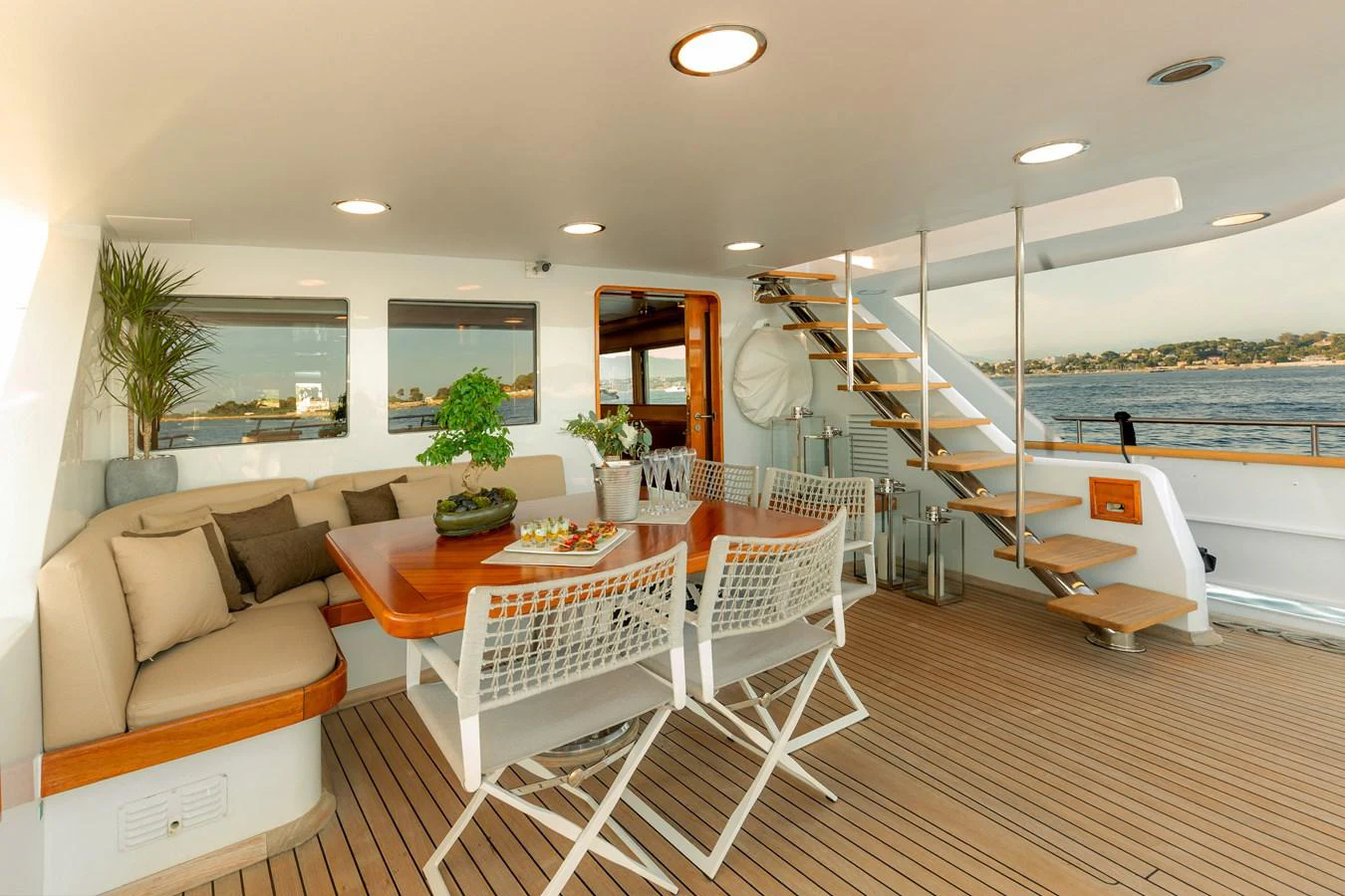 a room with a table chairs and a bench aboard ESPINOLA Yacht for Sale