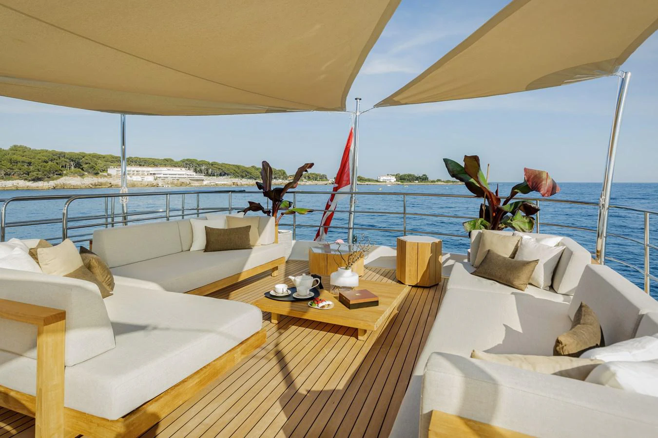 a room with a bed and a chair and a table with a plant on it aboard ESPINOLA Yacht for Sale