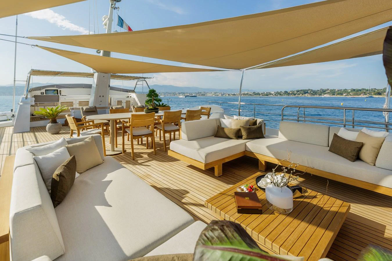 a large lounge area with a large white lounge chair and a large body of water aboard ESPINOLA Yacht for Sale