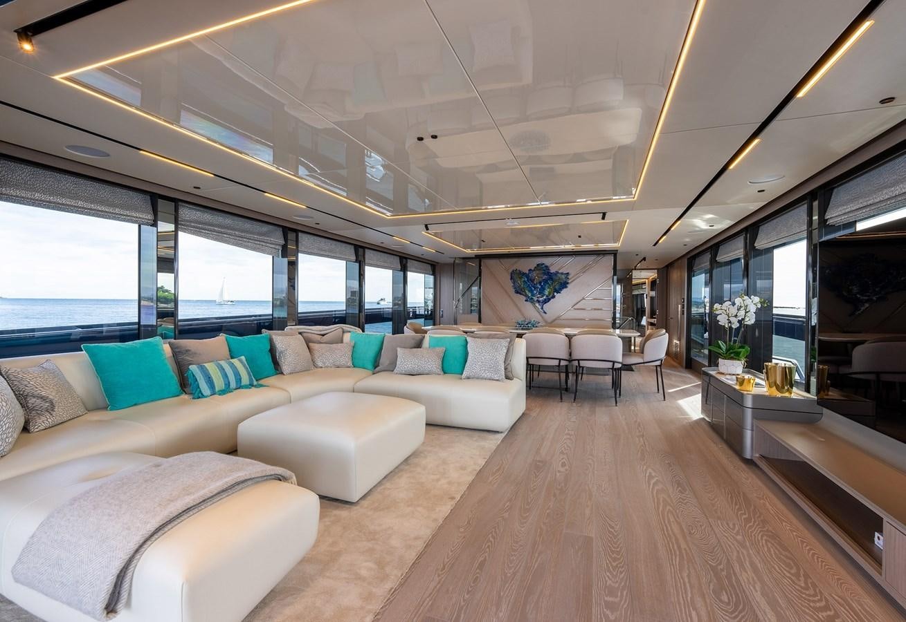 a living room with a large sofa aboard MAJIC Yacht for Sale