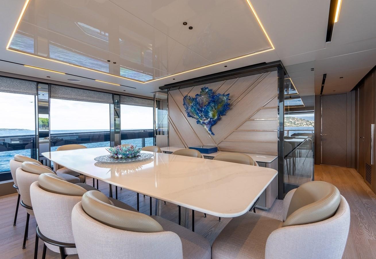 a room with a table chairs and a large window aboard MAJIC Yacht for Sale