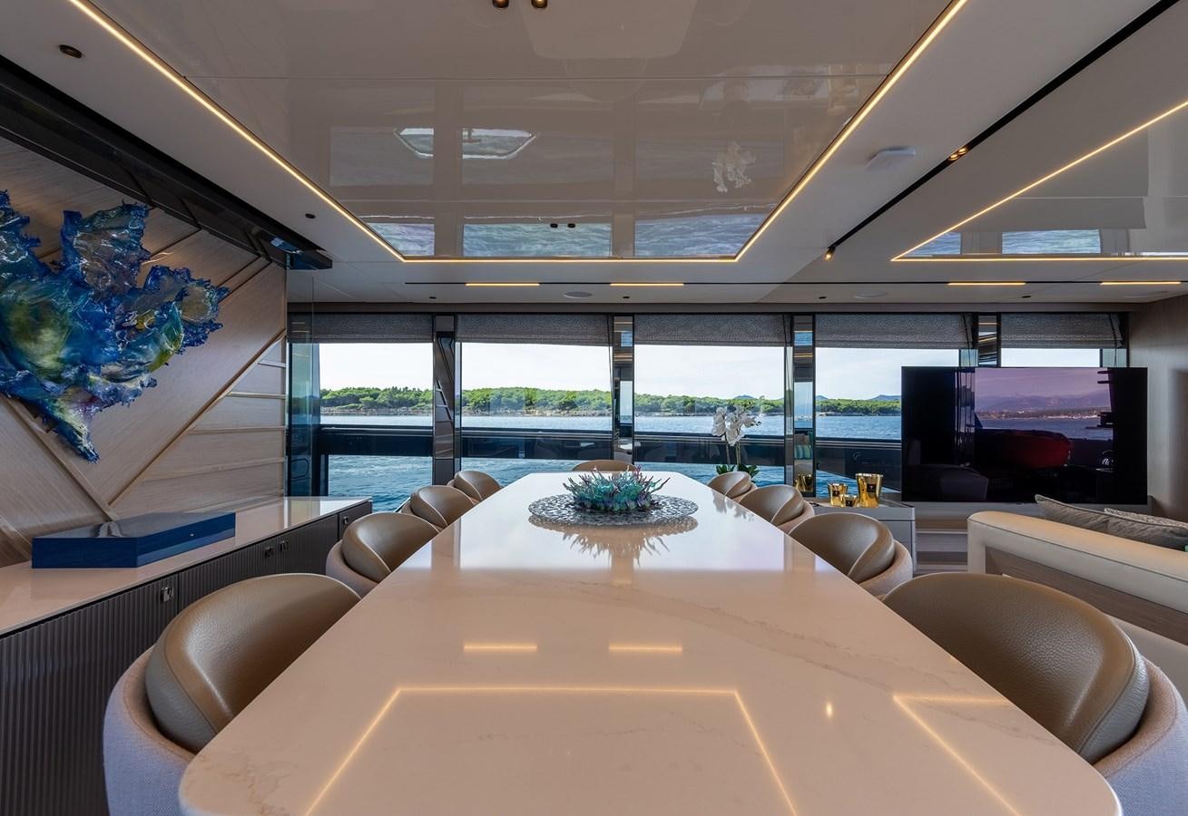 a large room with a large table and chairs aboard MAJIC Yacht for Sale