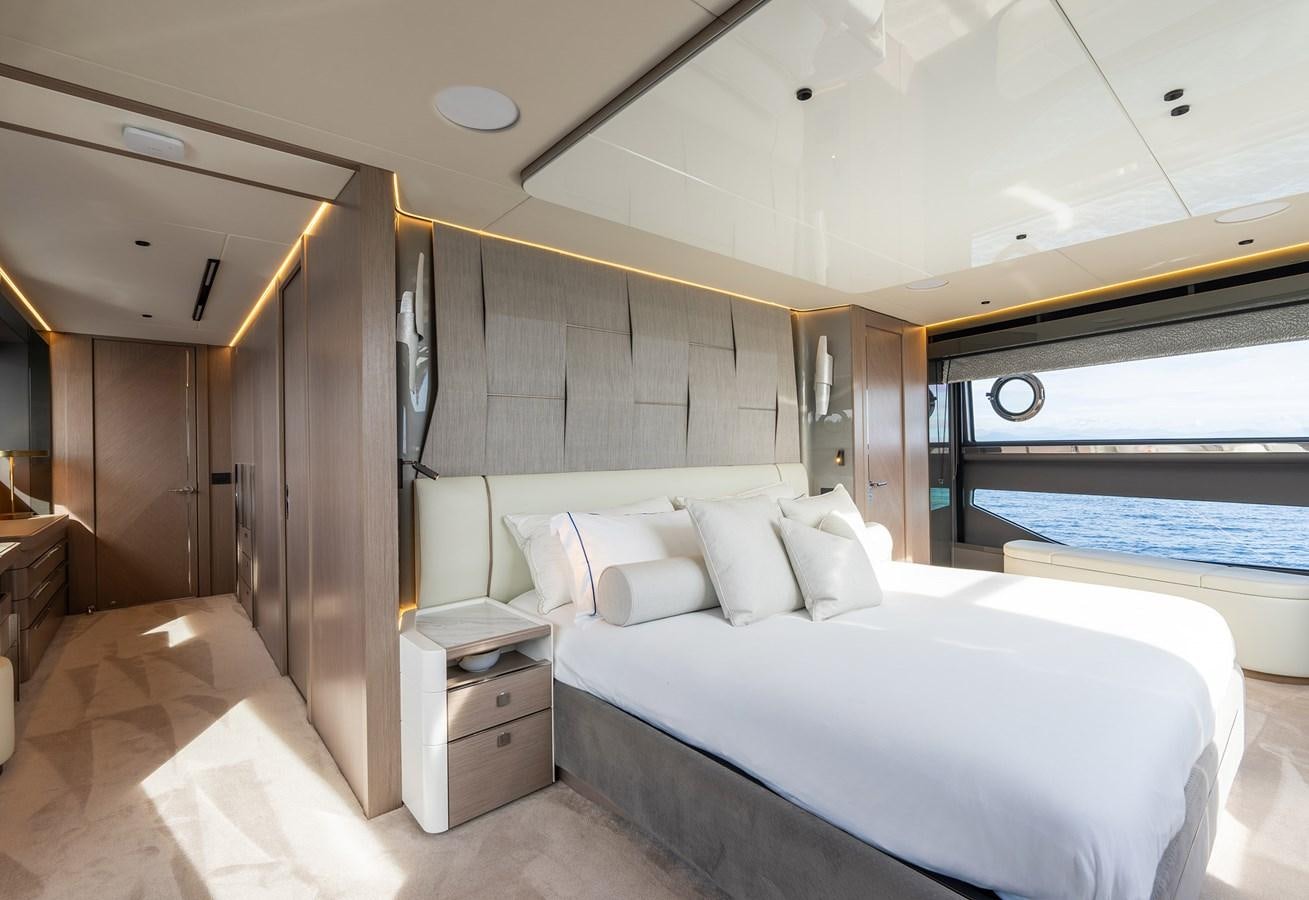 a room with a bed and a large window aboard MAJIC Yacht for Sale