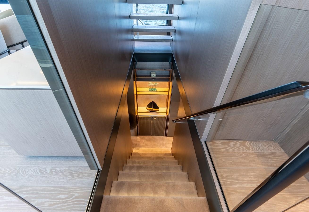 a wooden staircase with a wood railing aboard MAJIC Yacht for Sale