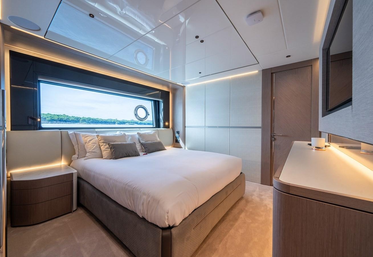a bedroom with a bed and a desk aboard MAJIC Yacht for Sale