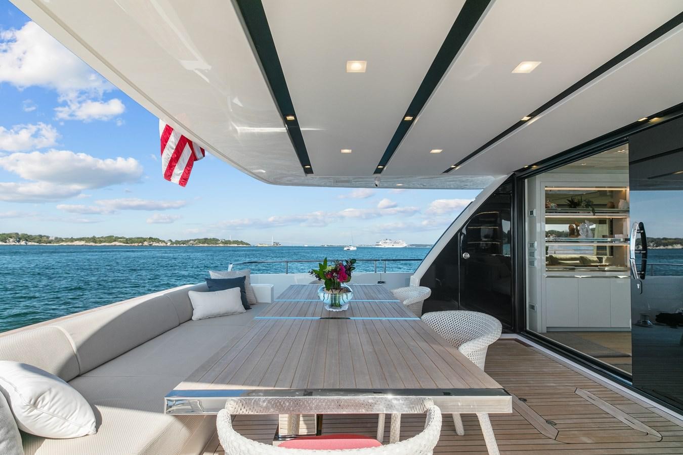 a deck with chairs and a body of water in the background aboard MISS LIZA Yacht for Sale