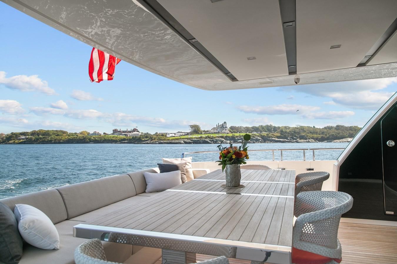 a table on a deck overlooking a body of water aboard MISS LIZA Yacht for Sale