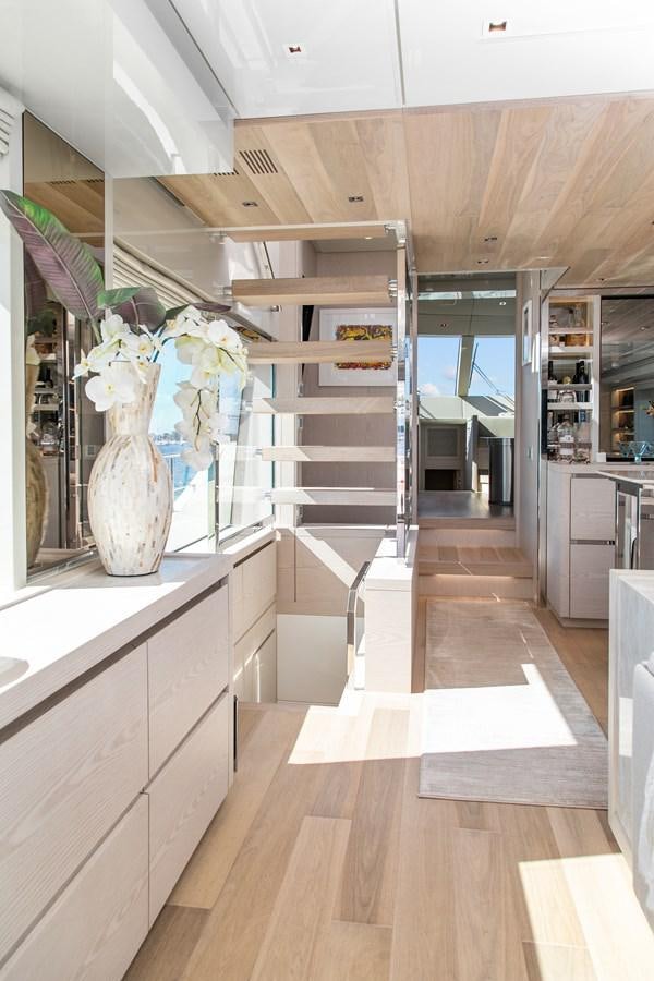 a room with a staircase and a vase with flowers aboard MISS LIZA Yacht for Sale