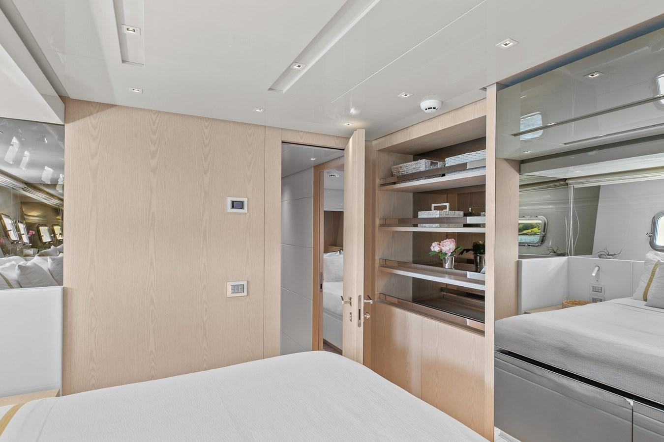 a room with a bed and a shelf with a mirror aboard MISS LIZA Yacht for Sale