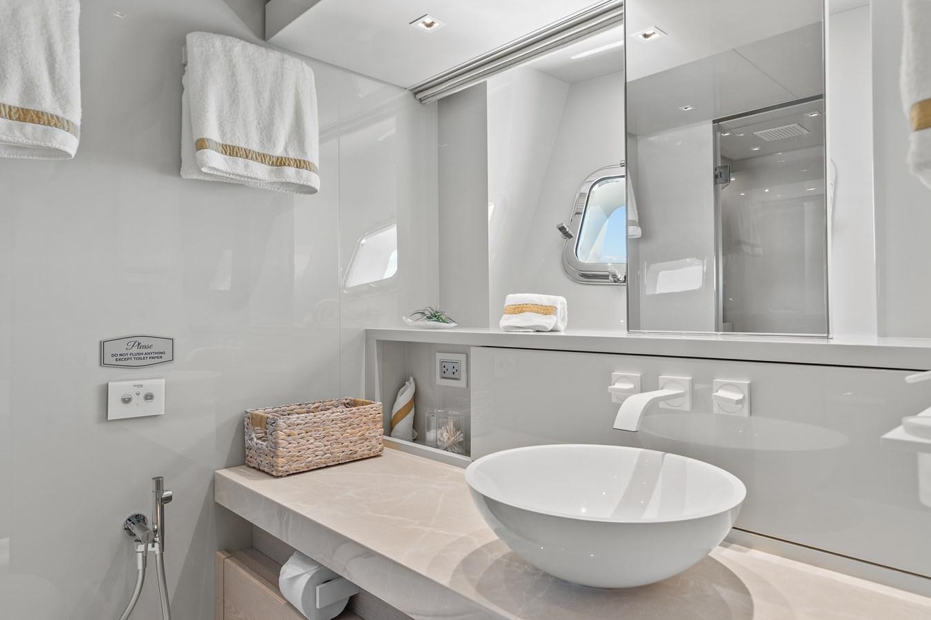 a bathroom with a sink and a large mirror aboard MISS LIZA Yacht for Sale