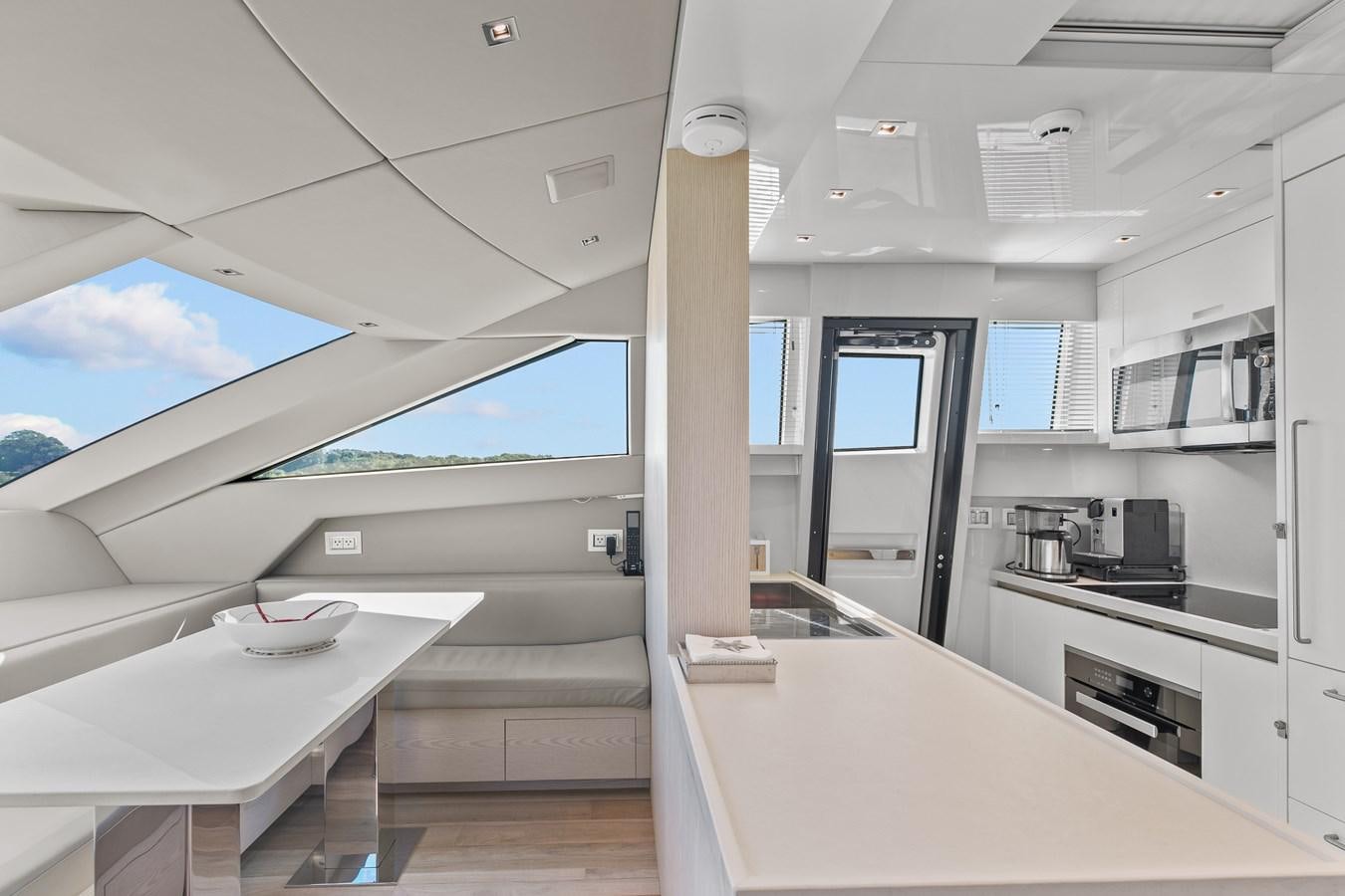 a room with a table and chairs aboard MISS LIZA Yacht for Sale