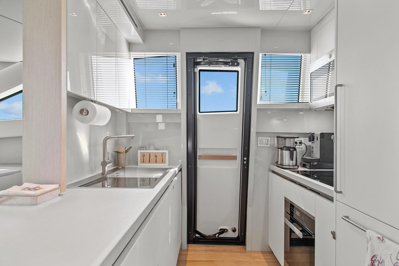 a kitchen with a sink and cabinets aboard MISS LIZA Yacht for Sale