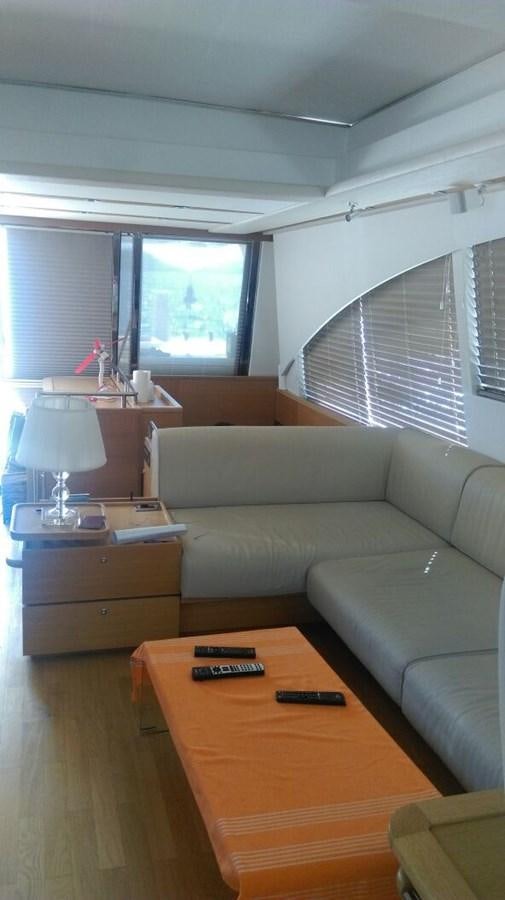 a living room with a couch and a television aboard SLO Yacht for Sale