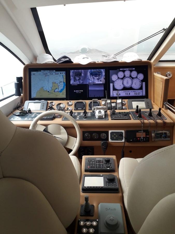 a desk with multiple computer monitors aboard SLO Yacht for Sale