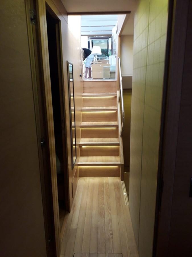 a hallway with a person standing on the stairs aboard SLO Yacht for Sale