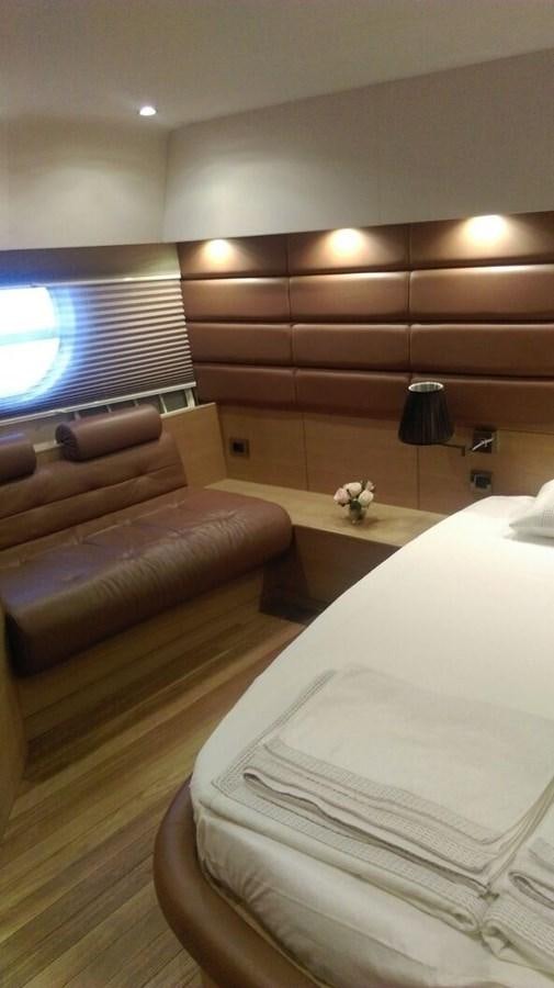a room with a bed and a couch aboard SLO Yacht for Sale