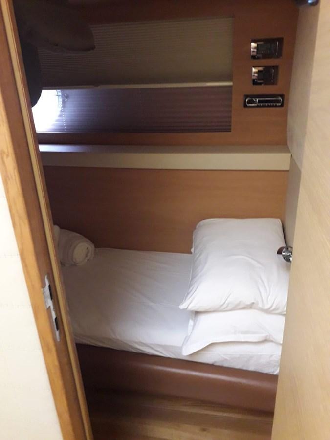 a bed with a white pillow aboard SLO Yacht for Sale