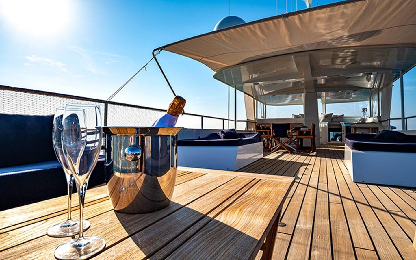 a glass of beer on a table aboard PERSUADER Yacht for Sale