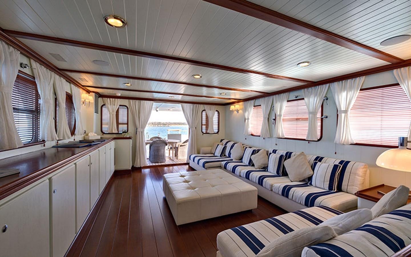 a large living room with a large open window aboard PERSUADER Yacht for Sale