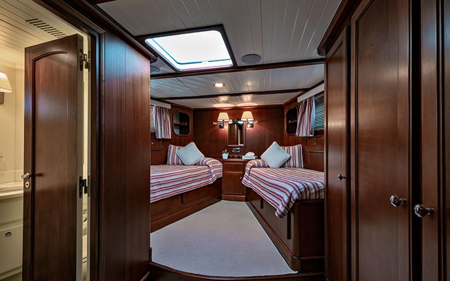 a room with a bed and a closet aboard PERSUADER Yacht for Sale