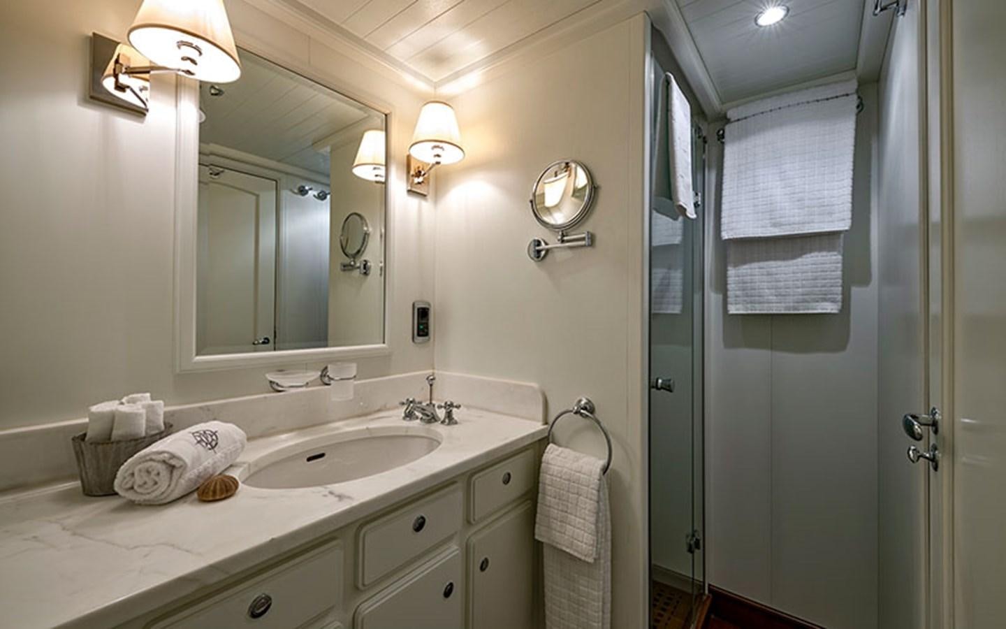 a bathroom with a sink and mirror aboard PERSUADER Yacht for Sale